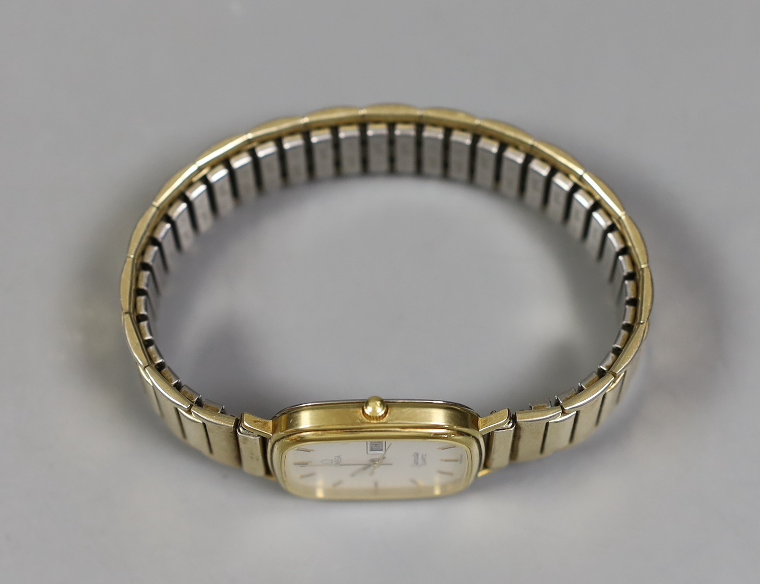 A gentleman's gold plated Omega Seamaster day/date quartz wrist watch, on associated flexible bracelet.